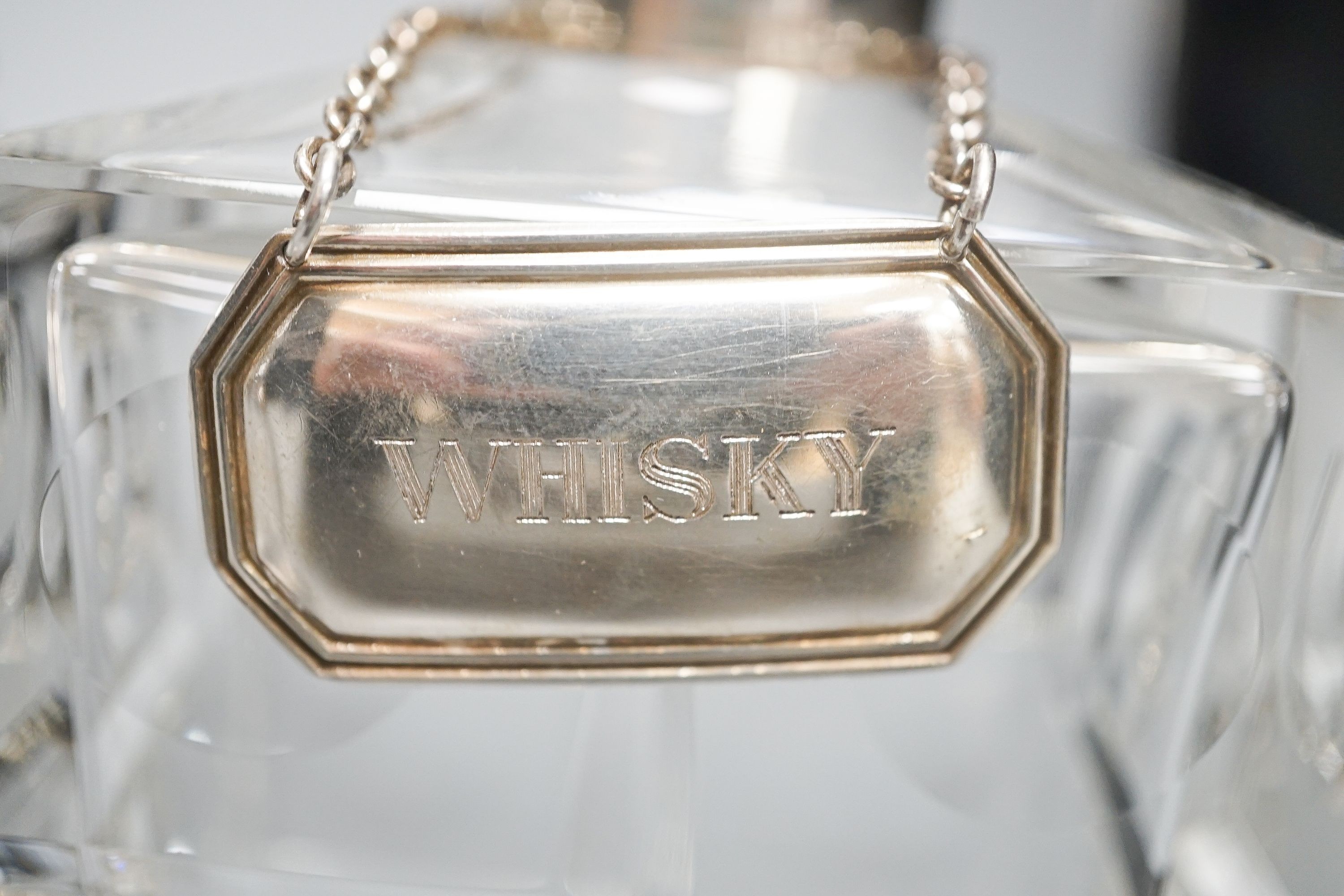 Four various glass decanters and silver labels for gin, brandy, vodka and whisky.